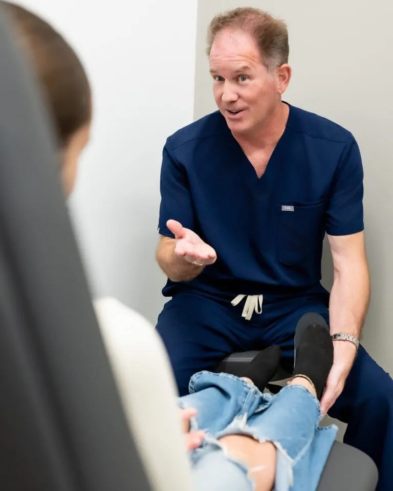 An Evolve Health physician talks with a patient during a clinic visit.