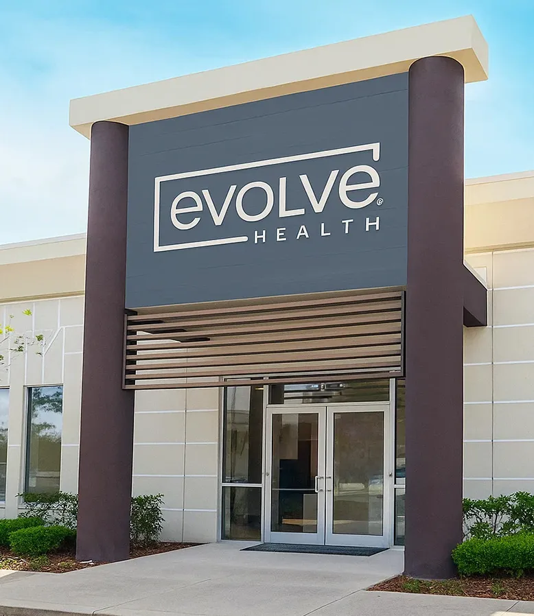 The exterior of an Evolve Health clinic with the new Evolve Health sign.