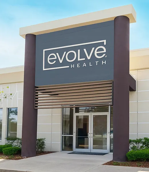 The exterior of an Evolve Health clinic with the new Evolve Health sign.
