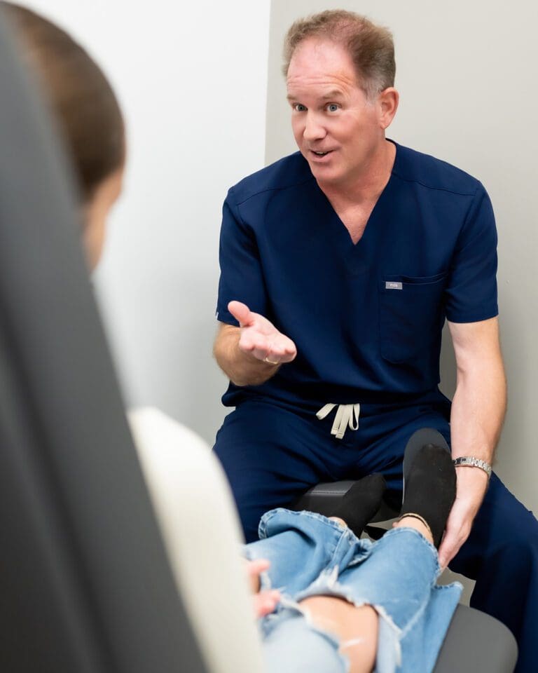 An Evolve Health physician talks with a patient during a clinic visit.
